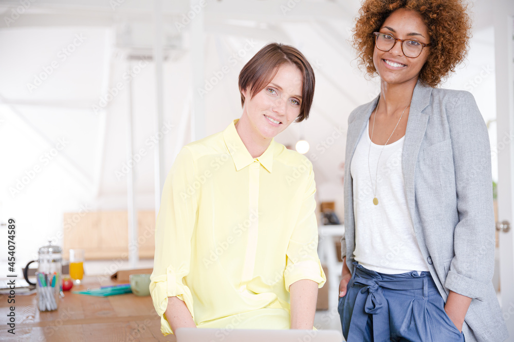 Fototapeta premium Portrait of two smiling office workers