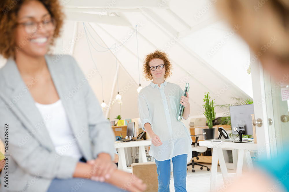 Woman walking and carrying laptop, joining colleague from office Woman walking and carrying laptop, joining colleague from office
