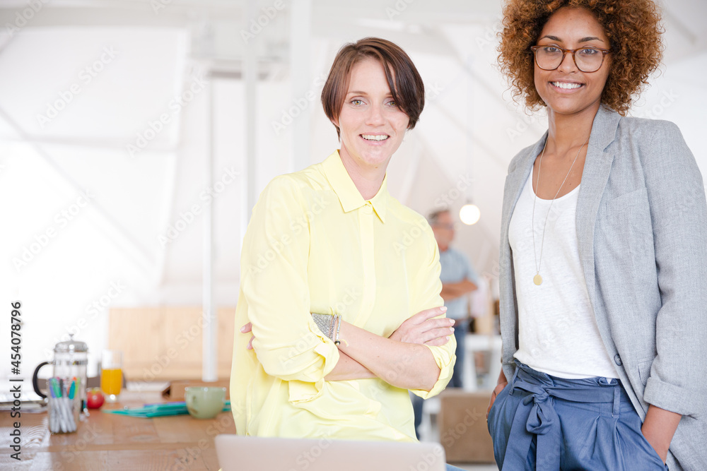 Portrait of two smiling office workers