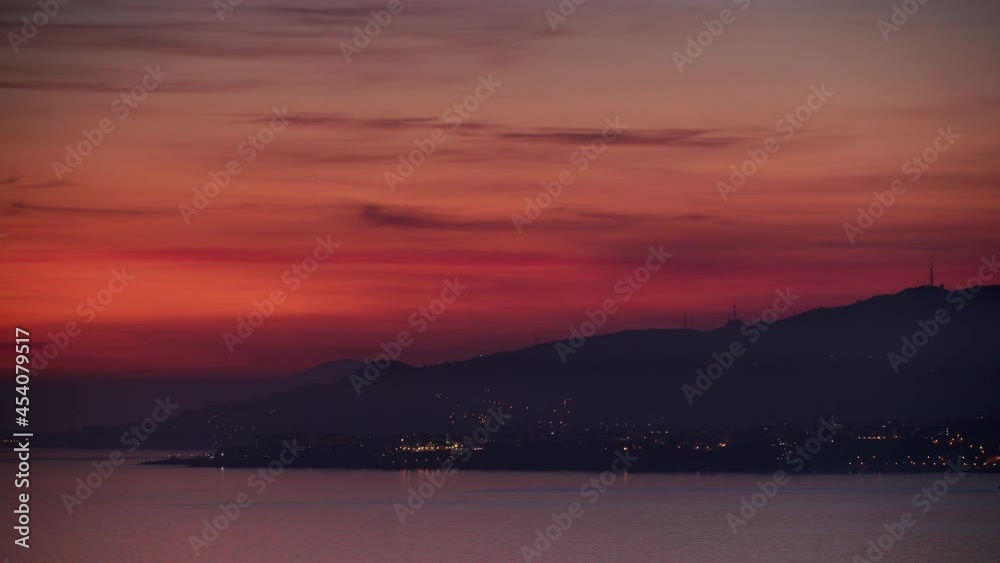 Seascape. Red orange sunset over sea coast. View from cliffs of Maro Cerro Gordo Natural Park, Malaga province, Costa Del Sol, Andalusia, Spain. Time lapse Seascape. Red orange sunset over sea coast. View from cliffs of Maro Cerro Gordo Natural Park, Malaga province, Costa Del Sol, Andalusia, Spain. Time lapse