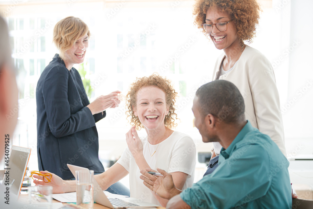 Fototapeta premium Office workers talking and smiling at meeting