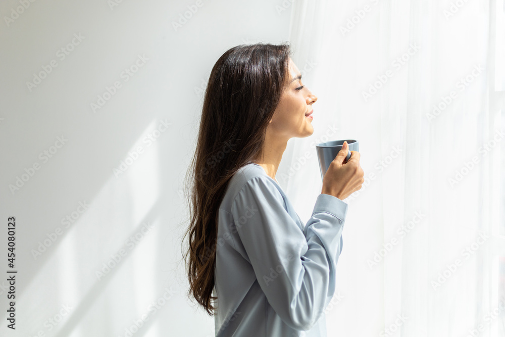 woman look at the scenery by the window and enjoying coffee. woman look at the scenery by the window and enjoying coffee.