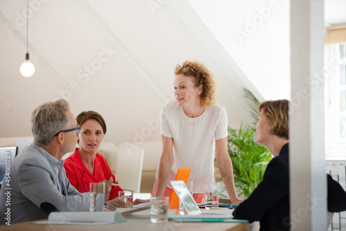 Office workers talking at desk