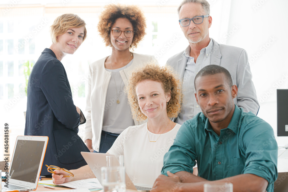 Portrait of office team smiling in conference room Portrait of office team smiling in conference room