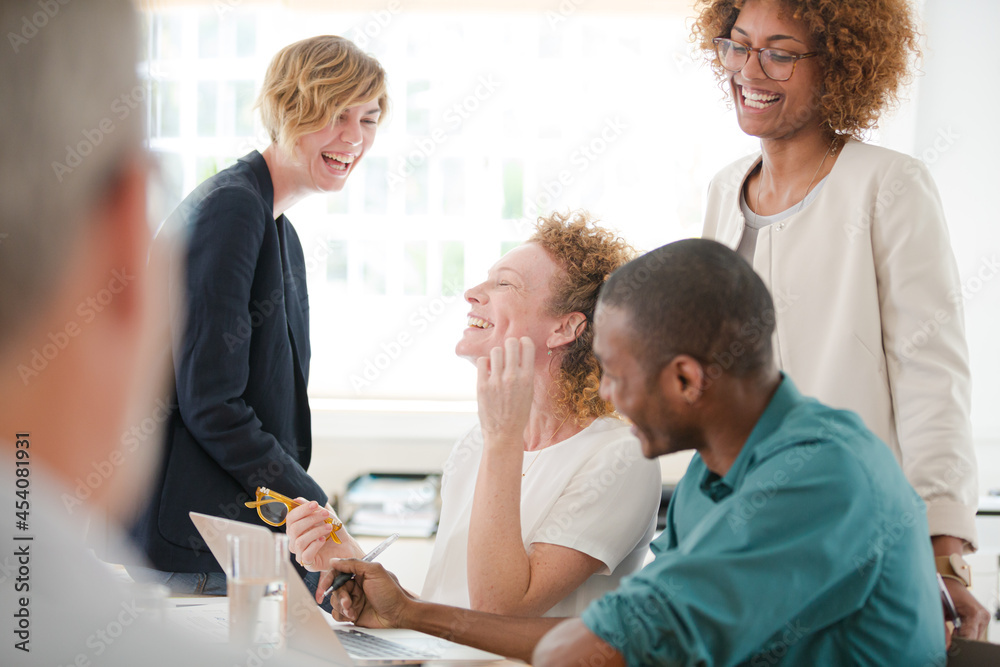 Fototapeta premium Office workers talking and smiling at meeting