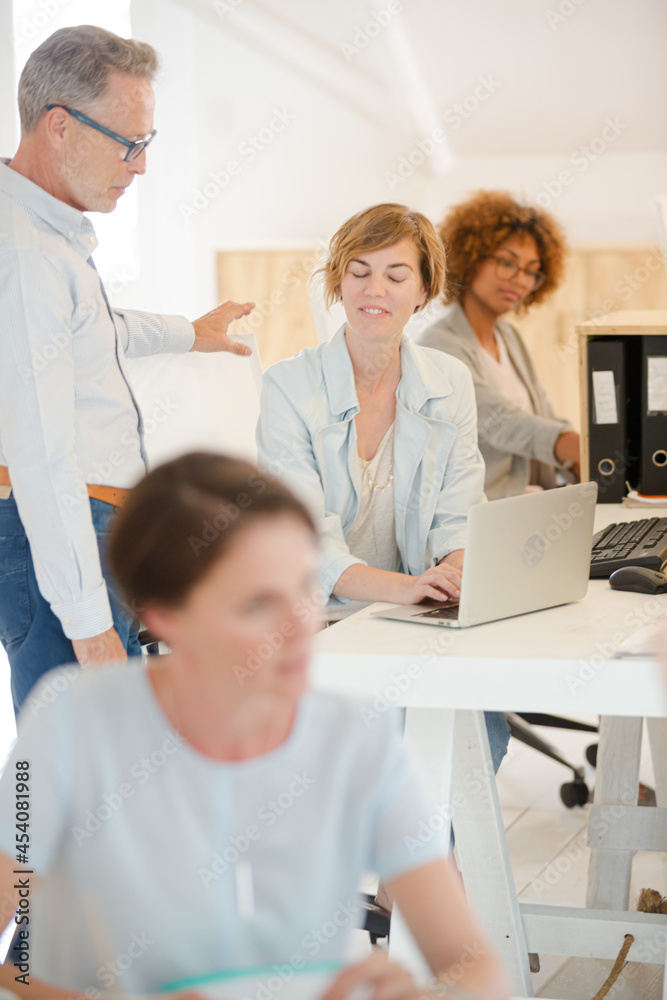Fototapeta premium Office workers talking at desk