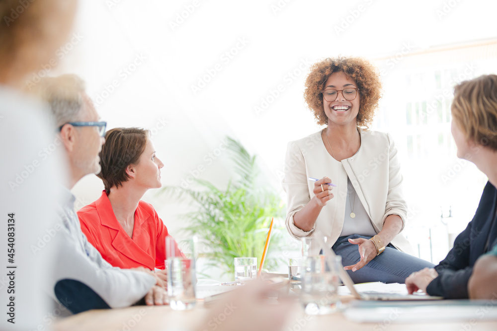Office workers talking at desk Office workers talking at desk