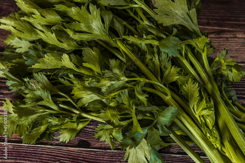 Tuber of celery with leaves, green bio vegetables from village gardening, farm fresh produce, organic food on wood