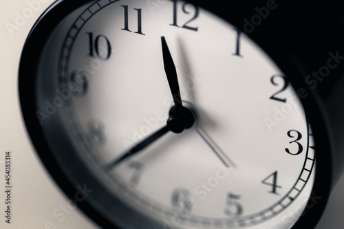 Soft focus on clockwise of black and white classic clock.