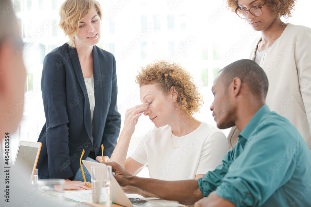 Office workers talking and smiling at meeting Office workers talking and smiling at meeting