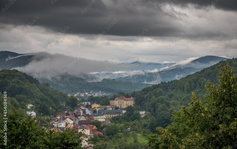 rain and heavy black clouds over a small town in the valley / Štramberk, Czech Republic