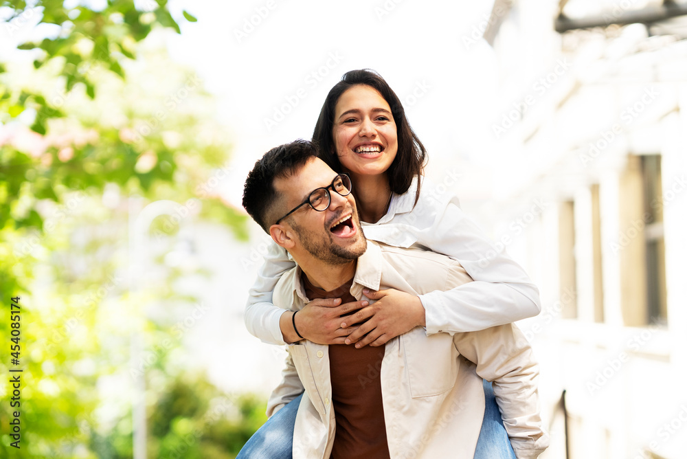 Happy young couple outdoors. Loving couple having fun together Happy young couple outdoors. Loving couple having fun together
