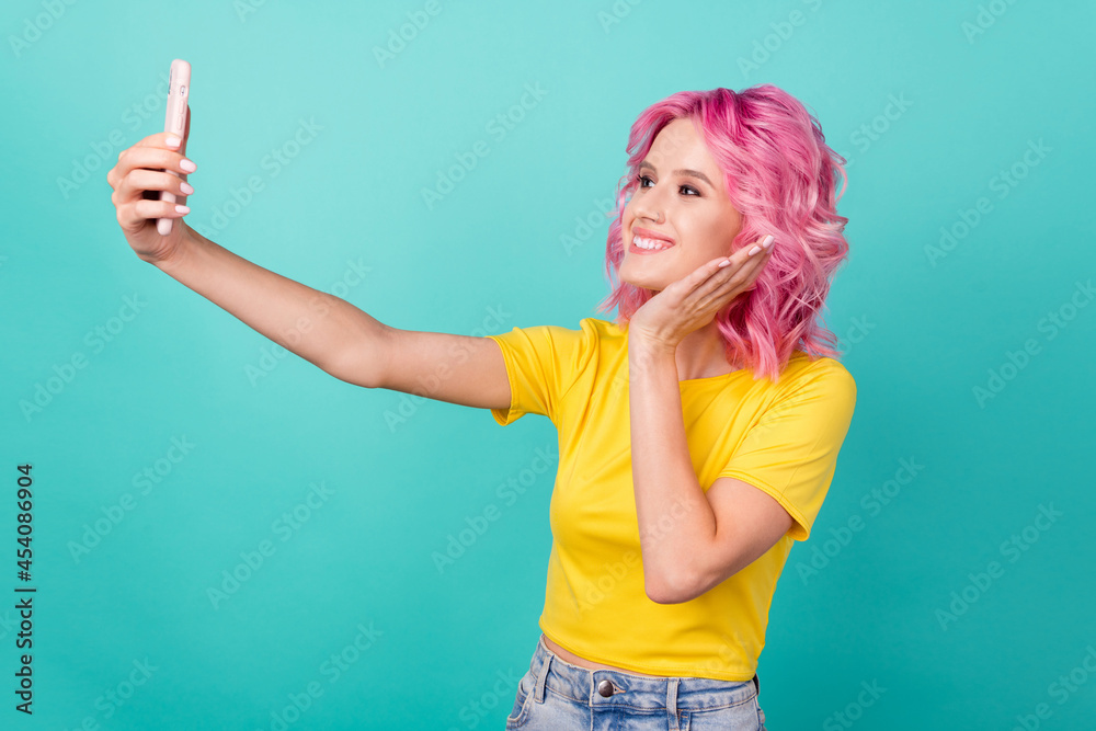 Profile photo of millennial cute pink hairdo lady do selfie wear yellow t-shirt isolated on teal background Profile photo of millennial cute pink hairdo lady do selfie wear yellow t-shirt isolated on teal background