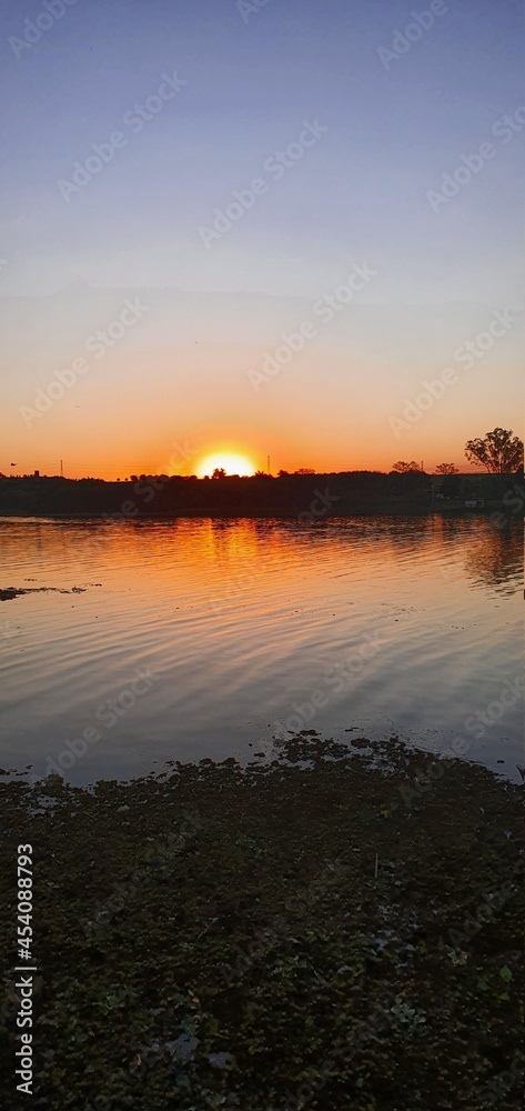 Obraz premium sunset over the river