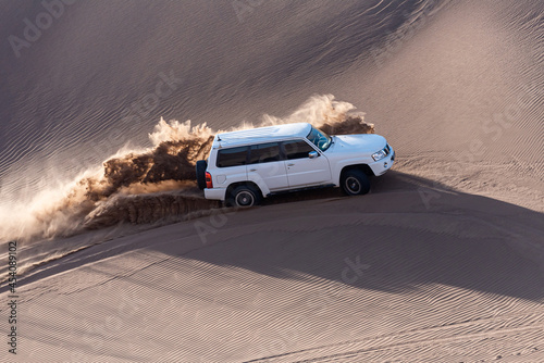 white car in dasht e lut or sahara desert © AAref