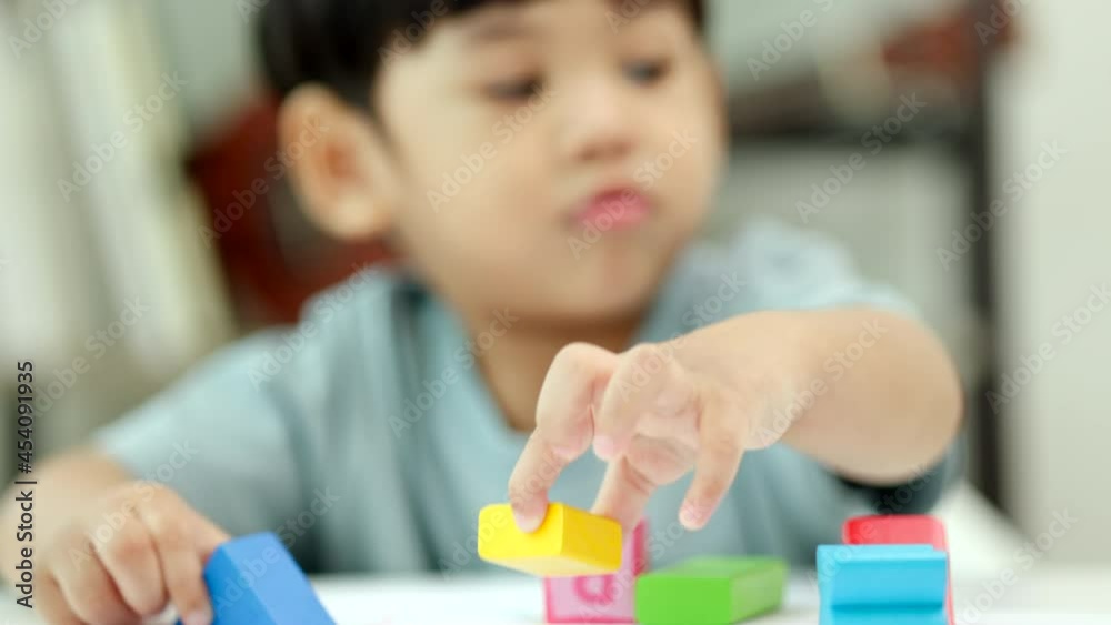 Close up shot. Asian little boy education from home. Developing children's learning before entering kindergarten Practice the skills of playing with wooden toys and drawing and painting.
Close up shot. Asian little boy education from home. Developing children's learning before entering kindergarten Practice the skills of playing with wooden toys and drawing and painting.
