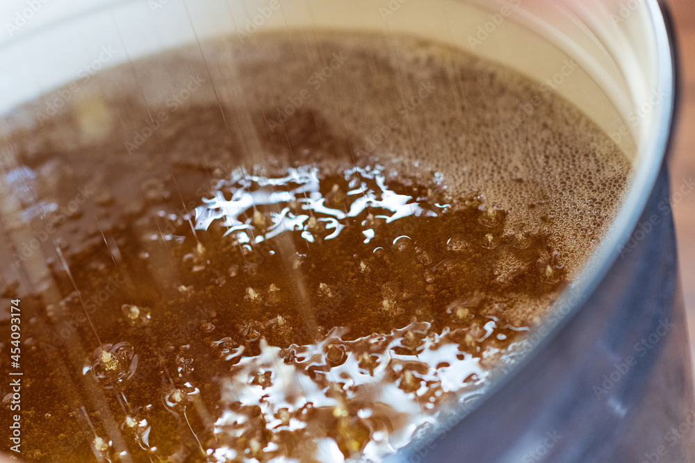 Drop of bee honey drip from hexagonal honeycombs Drop of bee honey drip from hexagonal honeycombs