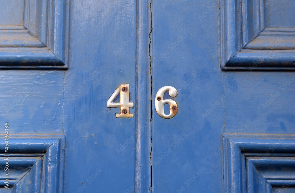 Close up of Brass Number '46' on Old Painted Wooden Door Close up of Brass Number '46' on Old Painted Wooden Door