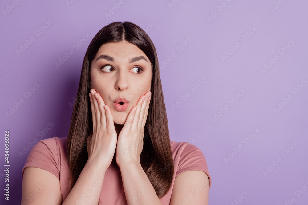 Portrait of attractive brunette girl opened mouth palms holding cheeks amazed look empty space isolated over violet background Portrait of attractive brunette girl opened mouth palms holding cheeks amazed look empty space isolated over violet background