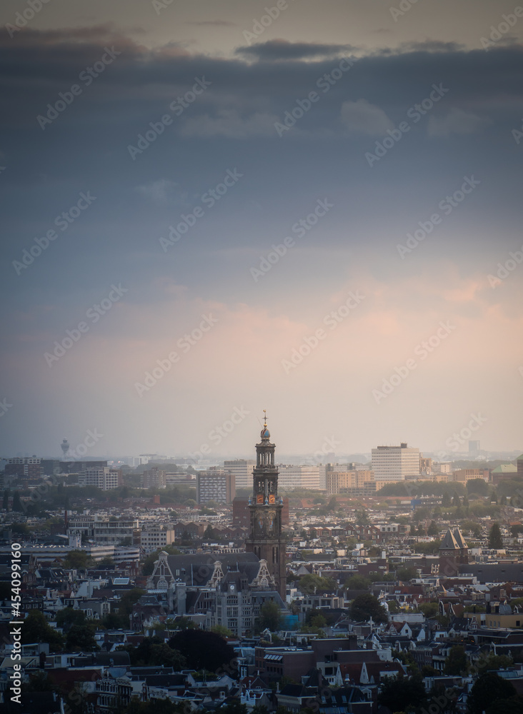 Aerial view of the city of Amsterdam, capital of the Netherlands on a calm summer evening, during cloudy sunset