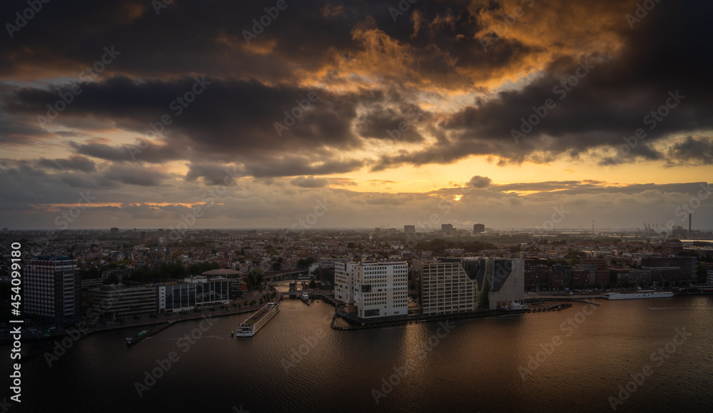 Aerial view of the city of Amsterdam, capital of the Netherlands on a calm summer evening, during cloudy sunset
