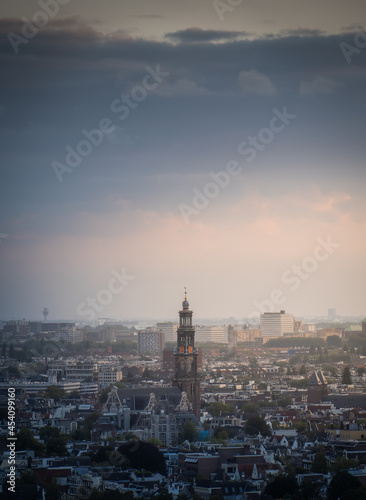 Aerial view of the city of Amsterdam, capital of the Netherlands on a calm summer evening, during cloudy sunset © Lorant