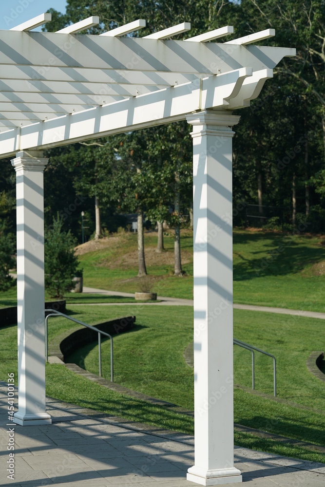 Fototapeta premium Pergola with slatted roof with shadows in public park