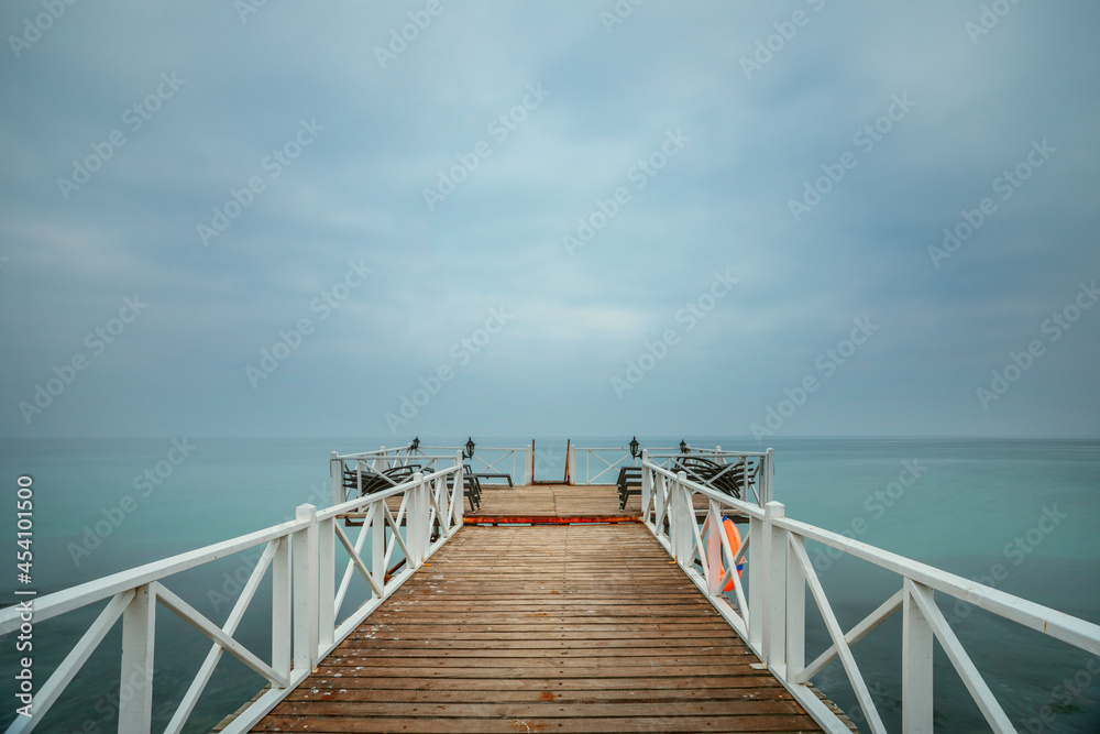 Pier with wooden plank flooring and hammocks to liven up the wait while enjoying the maritime horizon Pier with wooden plank flooring and hammocks to liven up the wait while enjoying the maritime horizon