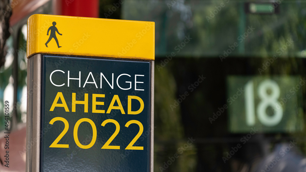 Change Ahead 2022 sign in a busy commuter city center
