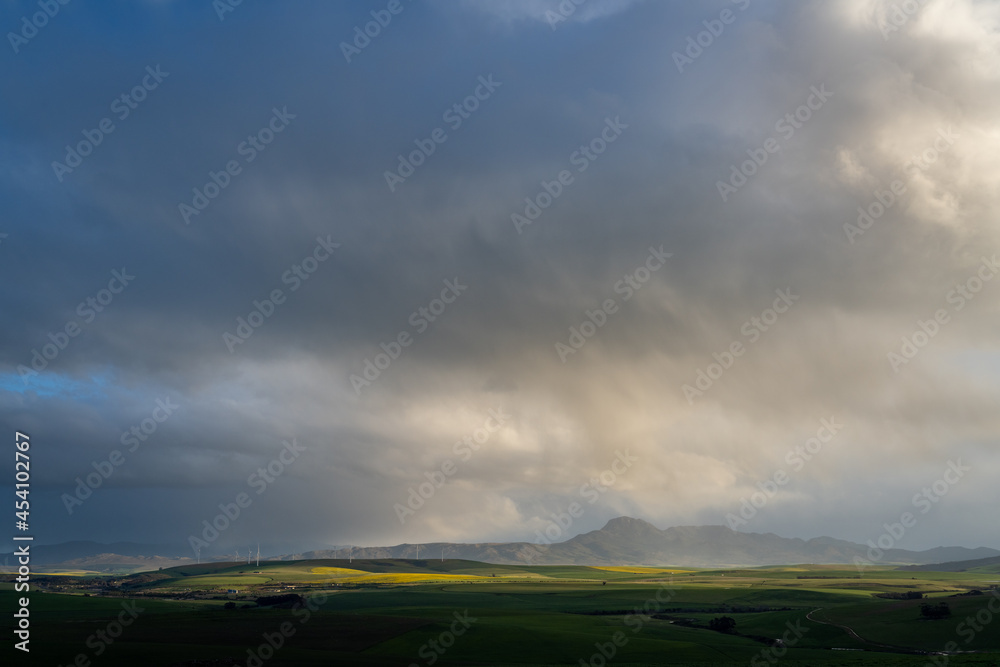 Storm clouds over farmlands and the Wind turbines on the 27 MW Klipheuwel Wind Farm. Near Caldon. Overberg. Western Cape. South Africa