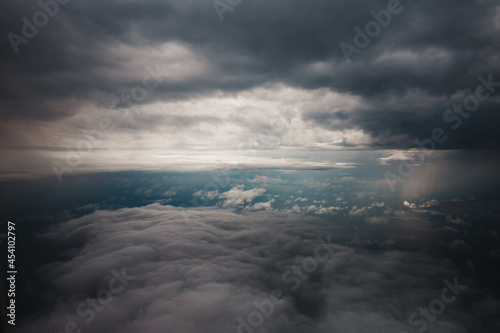 Spectacular view from the airplane window of the clouds in the sky - thick dense clouds of a thunderstorm front