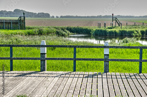 Schokland, The Netherlands, August 12, 2021: view from the reconstructed harbour constructions towards the polder that used to be sea untill the early 1940's
