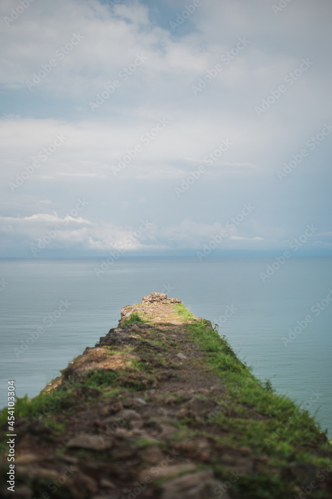 The fortress wall against the background of the sky and the sea - a place of loneliness