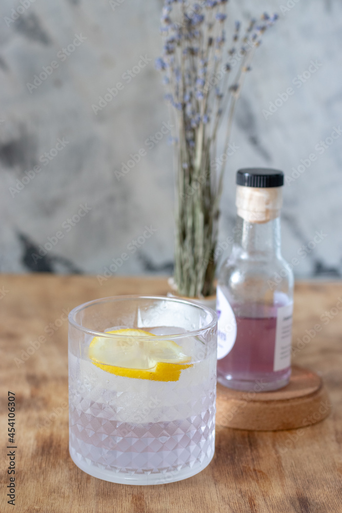 lavender lemonade with ice in a low glass glass stands on a table lavender lemonade with ice in a low glass glass stands on a table
