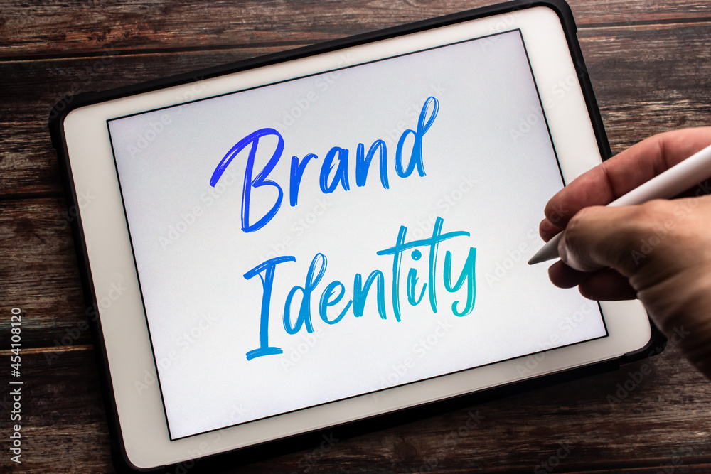Conceptual closeup keyword Brand Identity on tablet. Define the right image to consumer or clients. Concept of building brand image with creativity. Man hand holding wireless stylus pen Conceptual closeup keyword Brand Identity on tablet. Define the right image to consumer or clients. Concept of building brand image with creativity. Man hand holding wireless stylus pen