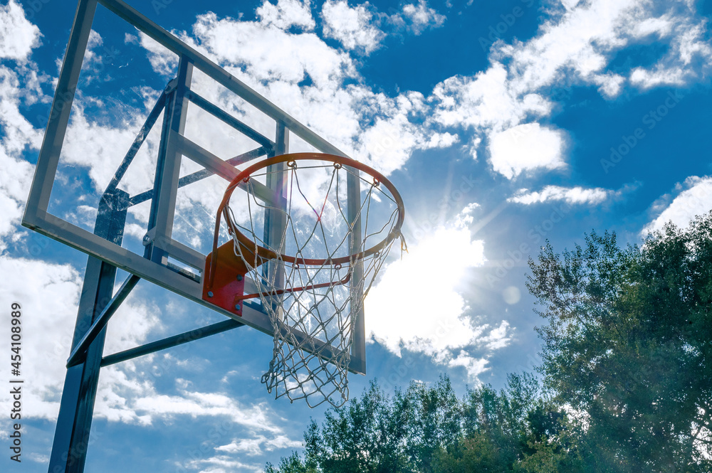 Basketball hoop against blue sky. Low angle view