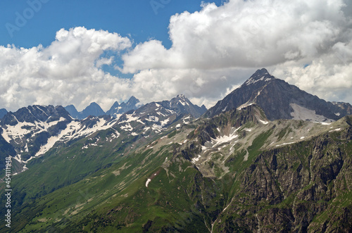 Beautiful mountain landscape of the Caucasus mountain range. Mountain peaks and clouds.