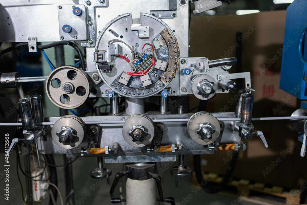 Fiber optic cable production machine, line in a factory in a workshop. Production of fiber optic and fiberglass cables for telecommunications. Fiber optic cable production machine, line in a factory in a workshop. Production of fiber optic and fiberglass cables for telecommunications.