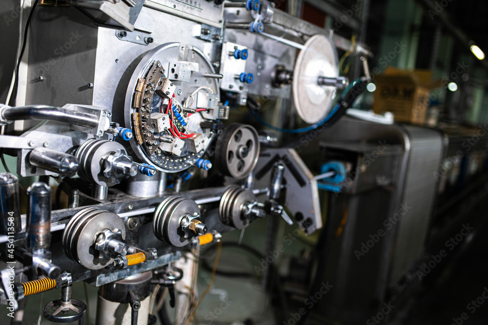 Fiber optic cable production machine, line in a factory in a workshop. Production of fiber optic and fiberglass cables for telecommunications.