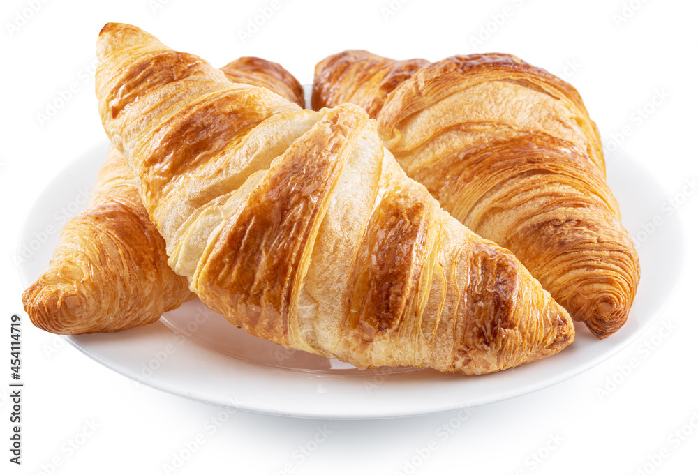 Tasty crusty croissants on the plate on white background. File contains clipping path.