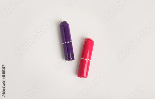 Two tampons on light background, flat lay