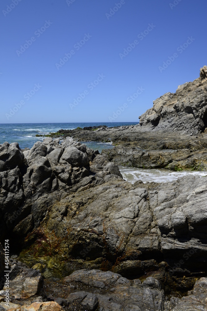 Vertical imaga of rocks and ocean waves at the pacific ocean near Todos Santos in the Baja peninsula at Baja california Sur, La Paz Todos Santos Mexico. LOS CERRITOS Beach 