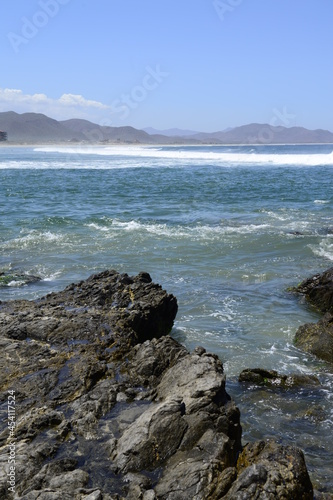 Vertical imaga of rocks and ocean waves at the pacific ocean near Todos Santos in the Baja peninsula at Baja california Sur, La Paz Todos Santos Mexico. LOS CERRITOS Beach  photo