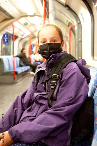 New normal. Young teenage girl with face covering mask on the subway. Mask against covid, pandemic. Teenager with face mask.