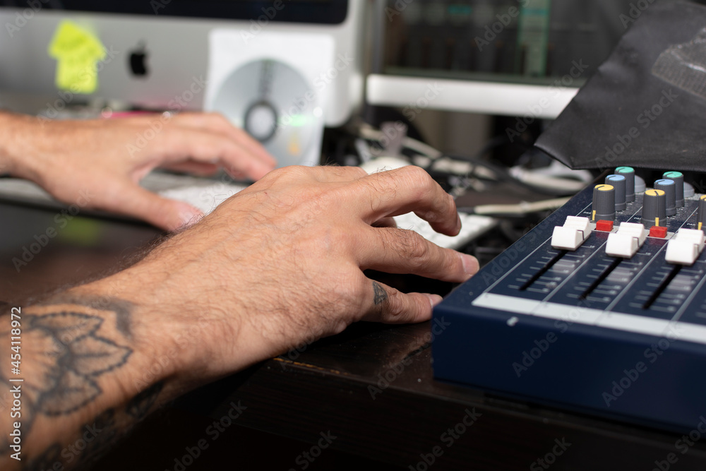 A male model creating music in his home studio A male model creating music in his home studio