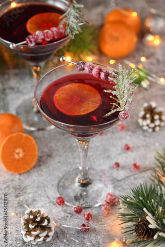 Goblet with cranberry Margarita with candied cranberries, rosemary and tangerine. Perfect cocktail for a Christmas party