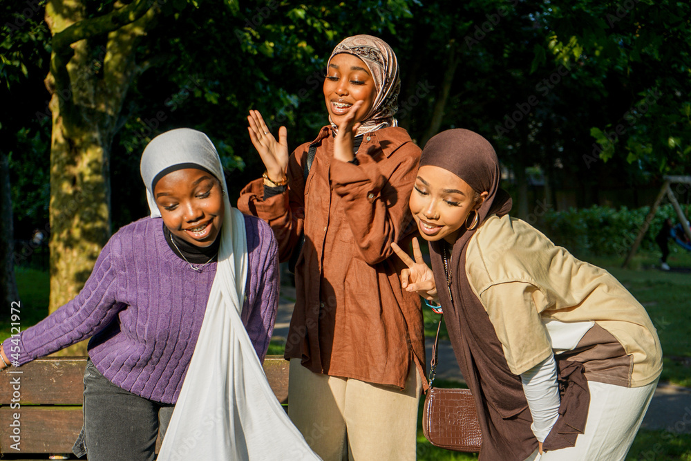 Portrait of three young women wearing hijabs in park