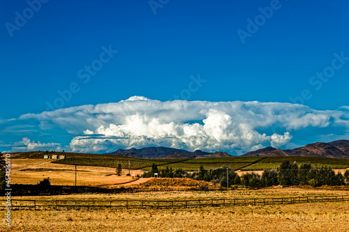 Large cumulonimbus cloud above distant mountains photo