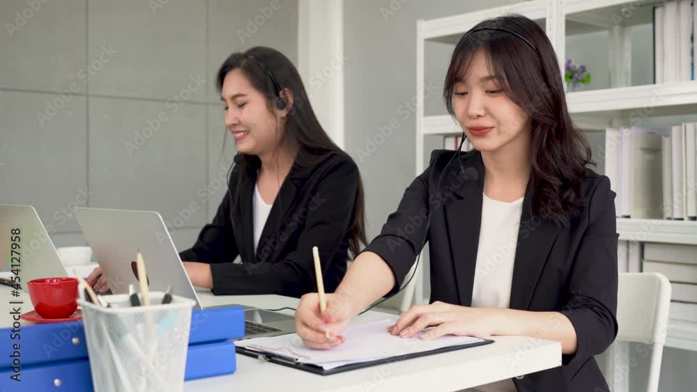 Call center or telemarketing taking notes and answering customer questions. Call center or telemarketing taking notes and answering customer questions.