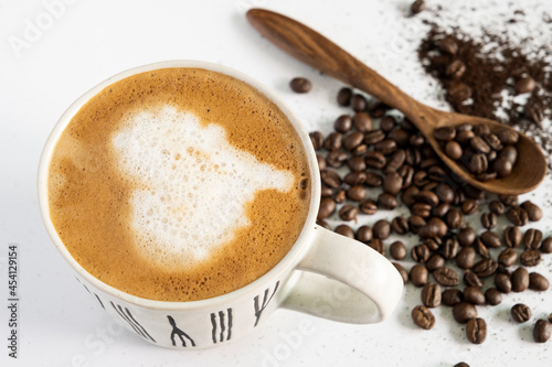 hot latte and coffee beans on white background